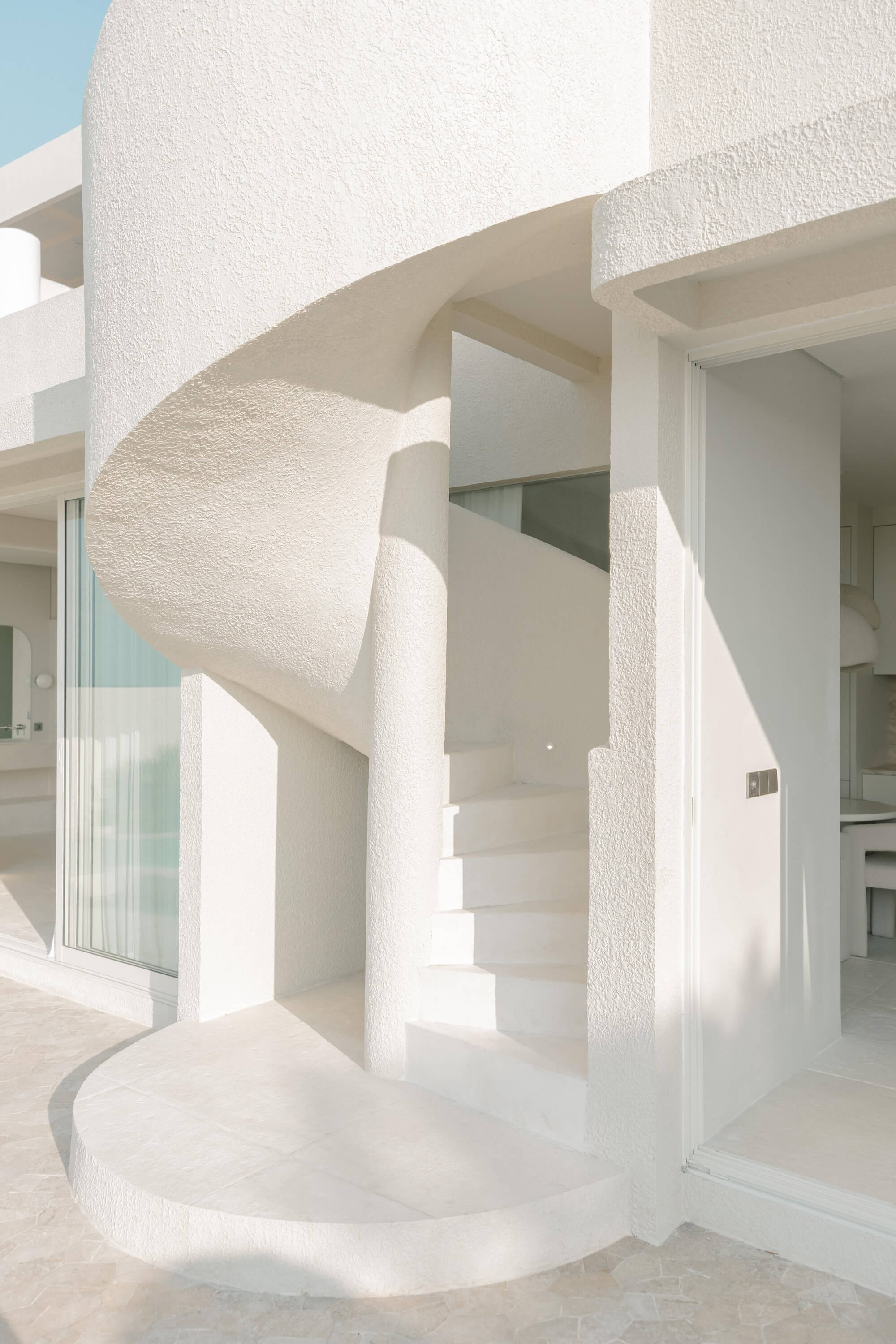 Minimalist architectural interior with curved walls and natural lighting