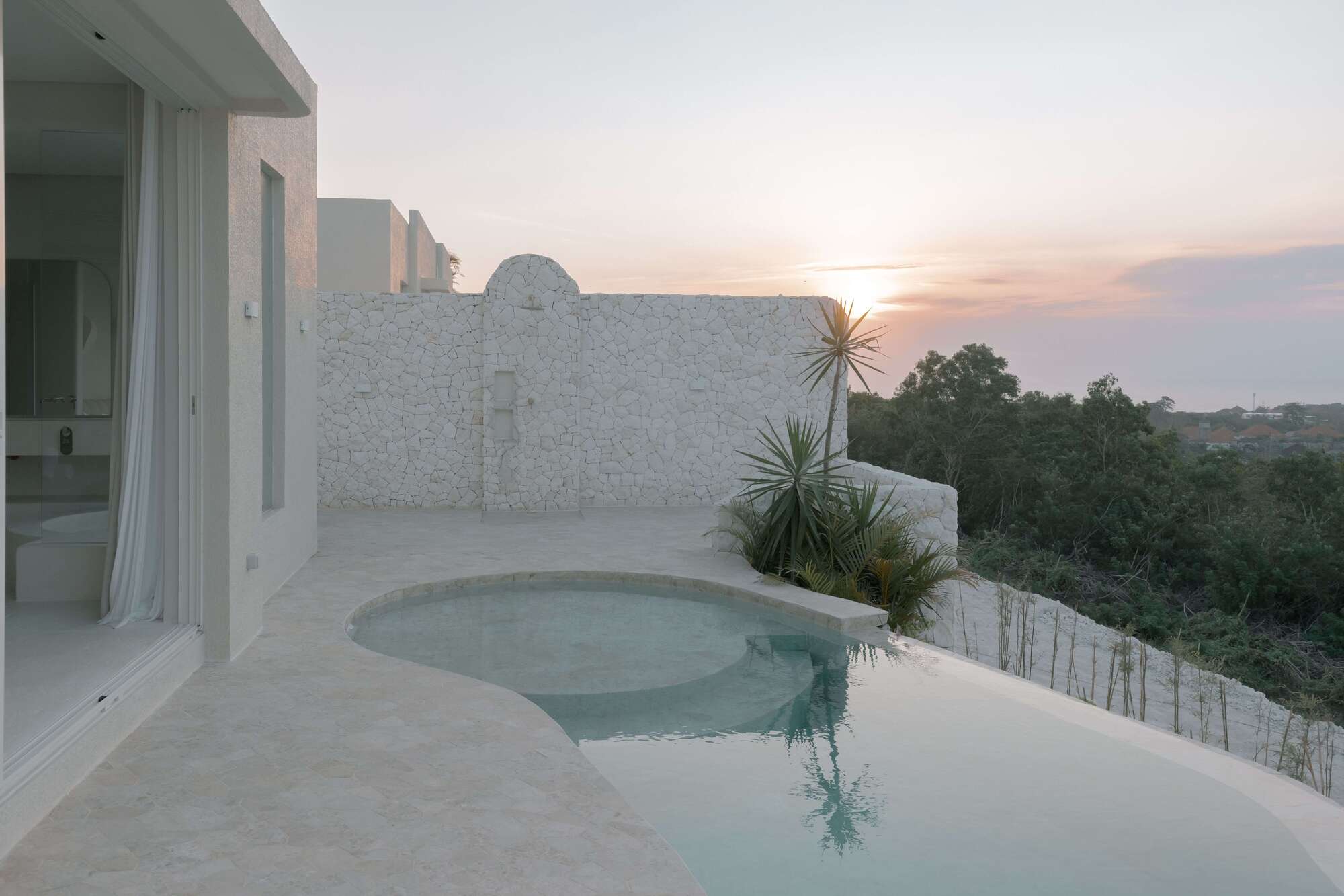Infinity pool with ocean view and modern architecture